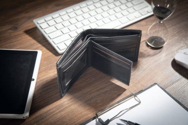 Boş cüzdan ve ahşap masada bir iş eşyası..