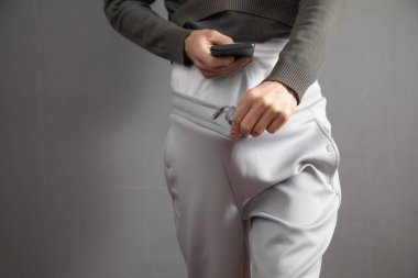 Man with a phone taking picture the penis.