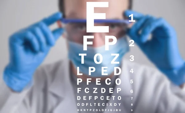 Doctor with a eye test chart.