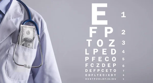 Doctor with a eye test chart.
