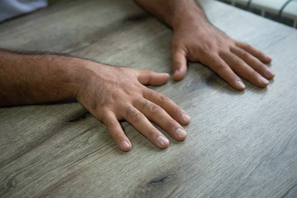 Caucasian human hand on the table.