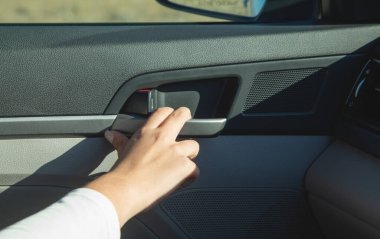 Female hand open car door from inside.