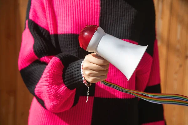 Caucasian young woman holding megaphone.