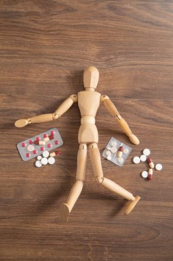 Tıbbi hapları olan tahta insan figürü..