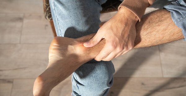 Caucasian man with pain in foot.