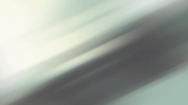 Çapraz yeşil ve gri renkler içeren bulanık bir arkaplan. Yumuşak bir şekilde beyaz ipuçlarıyla harmanlanmış. Çizgilerin dinamik hareketi modern ve soyut bir etki yaratıyor, çağdaş tasarımlar için mükemmel..