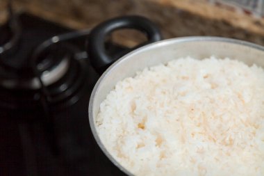 Fırının üstünde şömineyi yakan pilav pişiricisi. Pirinç kavramı. Yiyecek konsepti.