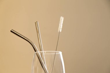 Mutfak tezgahında ekolojik kamış olan cam bardak. Döşeme arkaplanı ve kopyalama alanı var. Ekoloji konsepti. Konsepti yeniden kullan.