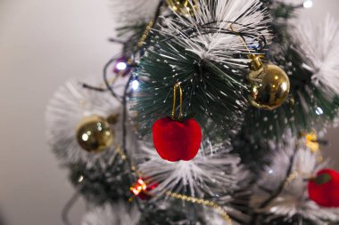 Close-up of balls on the Christmas tree with neutral background. Brazilian Christmas. Tree decoration. New year concept. Tree concept.	