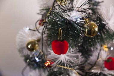 Close-up of balls on the Christmas tree with neutral background. Brazilian Christmas. Tree decoration. New year concept. Tree concept.	