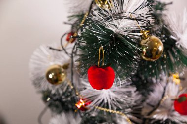 Close-up of balls on the Christmas tree with neutral background. Brazilian Christmas. Tree decoration. New year concept. Tree concept.	