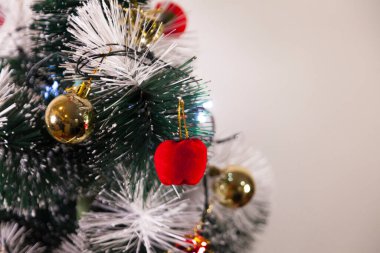 Close-up of balls on the Christmas tree with neutral background. Brazilian Christmas. Tree decoration. New year concept. Tree concept.	