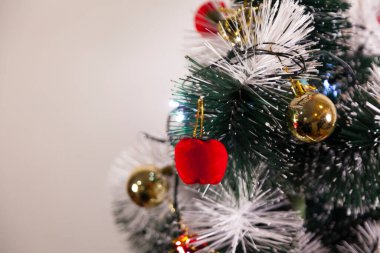 Close-up of balls on the Christmas tree with neutral background. Brazilian Christmas. Tree decoration. New year concept. Tree concept.	