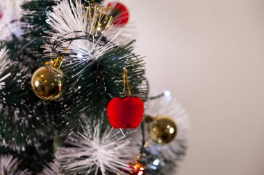 Close-up of balls on the Christmas tree with neutral background. Brazilian Christmas. Tree decoration. New year concept. Tree concept.	