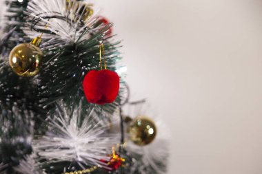 Close-up of balls on the Christmas tree with neutral background. Brazilian Christmas. Tree decoration. New year concept. Tree concept.	