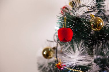 Close-up of balls on the Christmas tree with neutral background. Brazilian Christmas. Tree decoration. New year concept. Tree concept.	