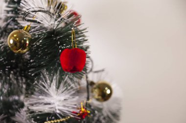Close-up of balls on the Christmas tree with neutral background. Brazilian Christmas. Tree decoration. New year concept. Tree concept.	