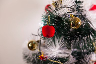 Close-up of balls on the Christmas tree with neutral background. Brazilian Christmas. Tree decoration. New year concept. Tree concept.	