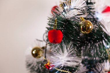 Close-up of balls on the Christmas tree with neutral background. Brazilian Christmas. Tree decoration. New year concept. Tree concept.	