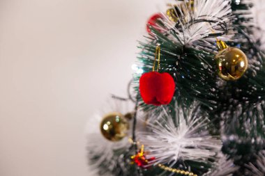 Close-up of balls on the Christmas tree with neutral background. Brazilian Christmas. Tree decoration. New year concept. Tree concept.	