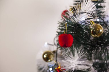 Close-up of balls on the Christmas tree with neutral background. Brazilian Christmas. Tree decoration. New year concept. Tree concept.	