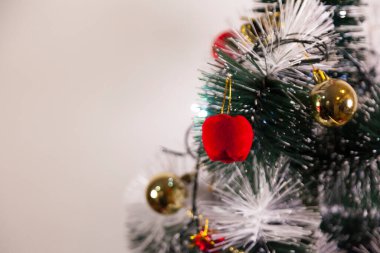 Close-up of balls on the Christmas tree with neutral background. Brazilian Christmas. Tree decoration. New year concept. Tree concept.	