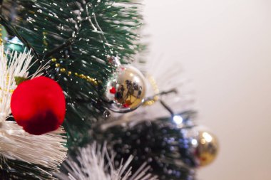 Close-up of balls on the Christmas tree with neutral background. Brazilian Christmas. Tree decoration. New year concept. Tree concept.	
