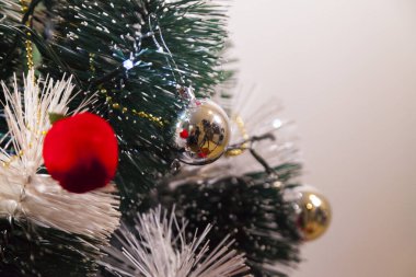 Close-up of balls on the Christmas tree with neutral background. Brazilian Christmas. Tree decoration. New year concept. Tree concept.	
