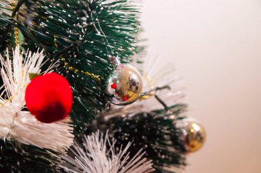 Close-up of balls on the Christmas tree with neutral background. Brazilian Christmas. Tree decoration. New year concept. Tree concept.	