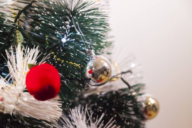 Close-up of balls on the Christmas tree with neutral background. Brazilian Christmas. Tree decoration. New year concept. Tree concept.	