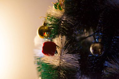 Close-up of balls on the Christmas tree with neutral background. Brazilian Christmas. Tree decoration. New year concept. Tree concept.	