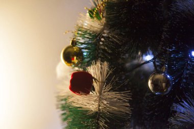 Close-up of balls on the Christmas tree with neutral background. Brazilian Christmas. Tree decoration. New year concept. Tree concept.	