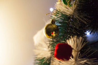 Close-up of balls on the Christmas tree with neutral background. Brazilian Christmas. Tree decoration. New year concept. Tree concept.	