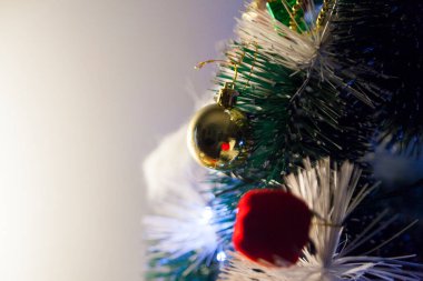 Close-up of balls on the Christmas tree with neutral background. Brazilian Christmas. Tree decoration. New year concept. Tree concept.	