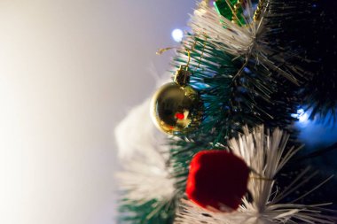 Close-up of balls on the Christmas tree with neutral background. Brazilian Christmas. Tree decoration. New year concept. Tree concept.	
