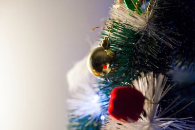 Close-up of balls on the Christmas tree with neutral background. Brazilian Christmas. Tree decoration. New year concept. Tree concept.	