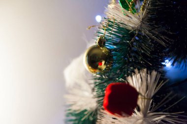 Close-up of balls on the Christmas tree with neutral background. Brazilian Christmas. Tree decoration. New year concept. Tree concept.	