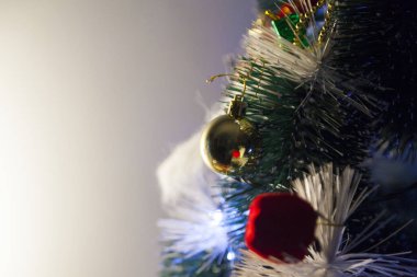Close-up of balls on the Christmas tree with neutral background. Brazilian Christmas. Tree decoration. New year concept. Tree concept.	
