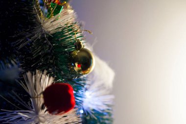Close-up of balls on the Christmas tree with neutral background. Brazilian Christmas. Tree decoration. New year concept. Tree concept.	