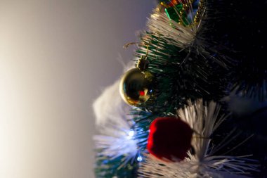 Close-up of balls on the Christmas tree with neutral background. Brazilian Christmas. Tree decoration. New year concept. Tree concept.	
