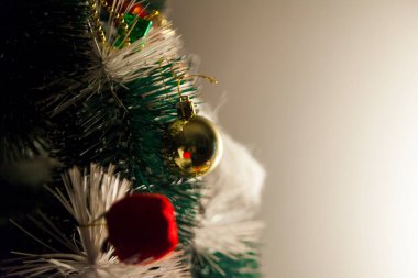 Close-up of balls on the Christmas tree with neutral background. Brazilian Christmas. Tree decoration. New year concept. Tree concept.	