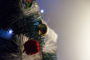 Close-up of balls on the Christmas tree with neutral background. Brazilian Christmas. Tree decoration. New year concept. Tree concept.	