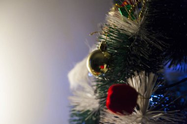 Close-up of balls on the Christmas tree with neutral background. Brazilian Christmas. Tree decoration. New year concept. Tree concept.	