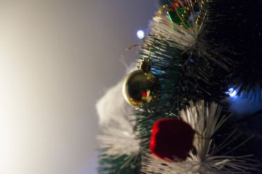 Close-up of balls on the Christmas tree with neutral background. Brazilian Christmas. Tree decoration. New year concept. Tree concept.	