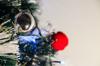 Close-up of balls on the Christmas tree with neutral background. Brazilian Christmas. Tree decoration. New year concept. Tree concept.	