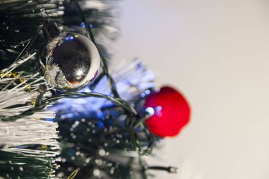 Close-up of balls on the Christmas tree with neutral background. Brazilian Christmas. Tree decoration. New year concept. Tree concept.	