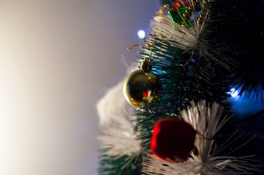 Close-up of balls on the Christmas tree with neutral background. Brazilian Christmas. Tree decoration. New year concept. Tree concept.	