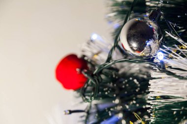 Close-up of balls on the Christmas tree with neutral background. Brazilian Christmas. Tree decoration. New year concept. Tree concept.	