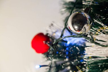 Close-up of balls on the Christmas tree with neutral background. Brazilian Christmas. Tree decoration. New year concept. Tree concept.	