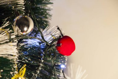 Close-up of balls on the Christmas tree with neutral background. Brazilian Christmas. Tree decoration. New year concept. Tree concept.	